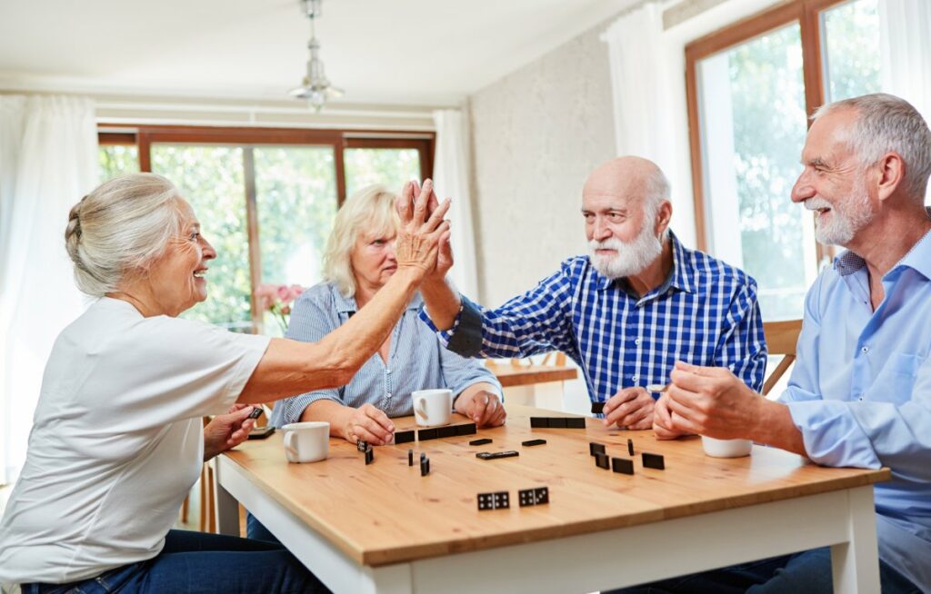 Austin Senior Living | Happy group of seniors playing a game