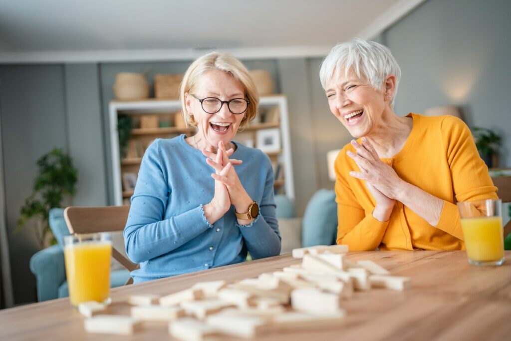 Austin Senior Living | Two happy senior women playing a game